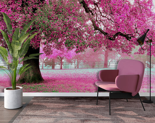 Pink chair in front of a wall mural of cherry blossoms