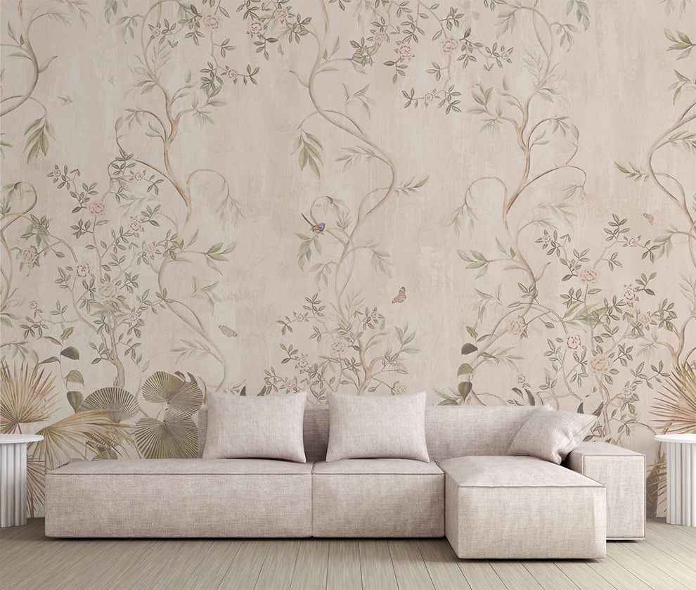 Beige sectional sofa in front of floral wallpaper