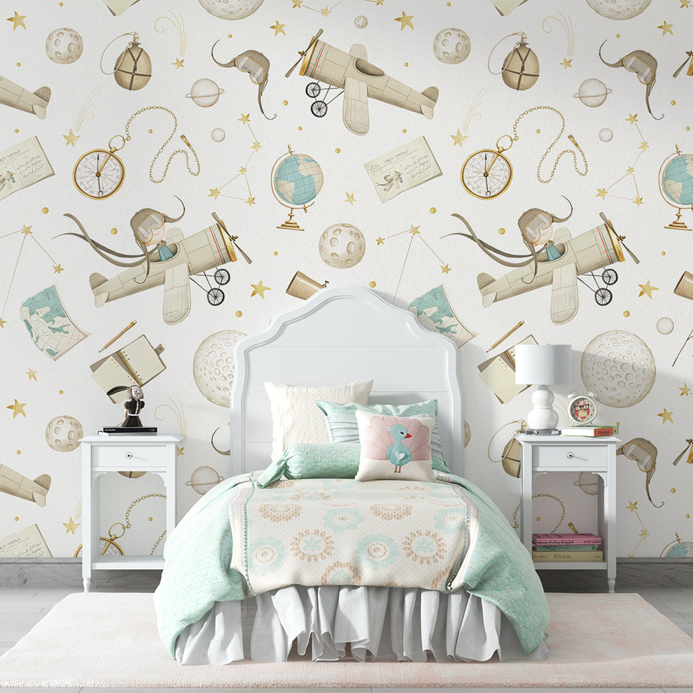 Children's bedroom with airplane and globe patterned wallpaper.